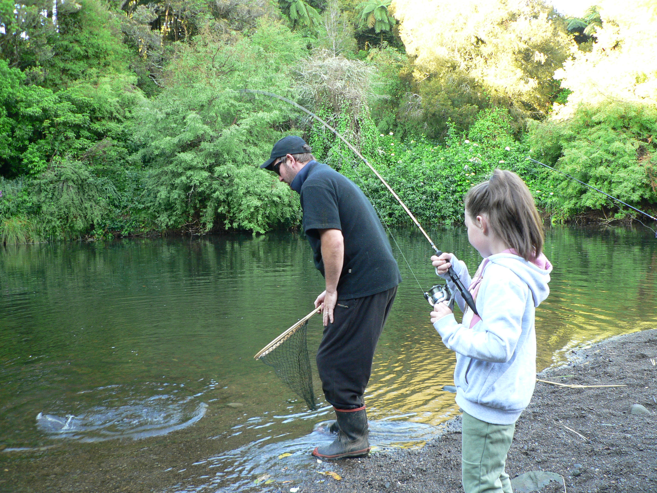 TRL2Jan19. McKenzie Reed plays a trout at the Stratford fishing day with volunteer Kingsley Young at the ready
