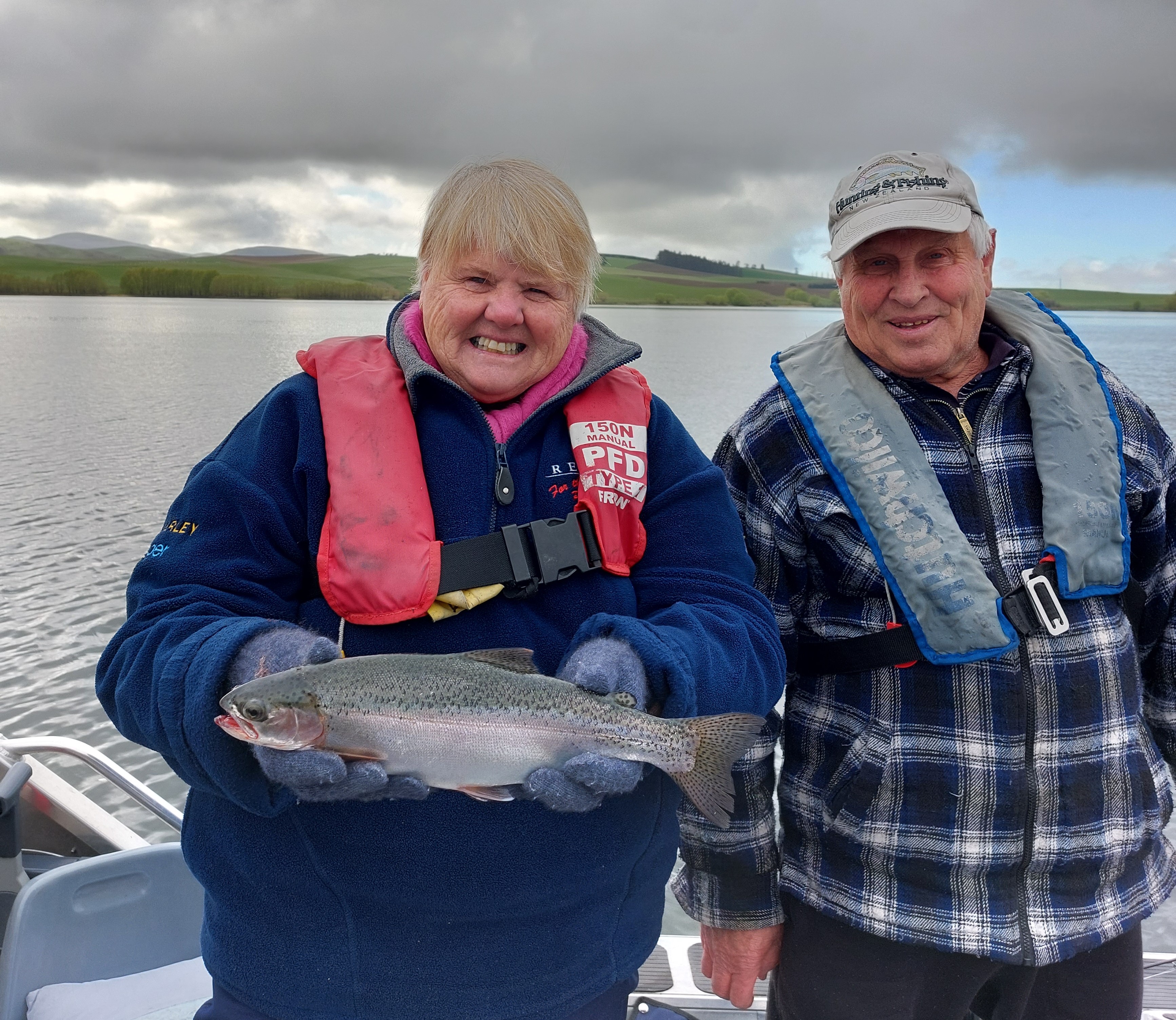 Photo 1 Kristen and Robert McKey of Christchurch with a rainbow trout from Lake Opuha on opening day of the 2022 sports fishing season