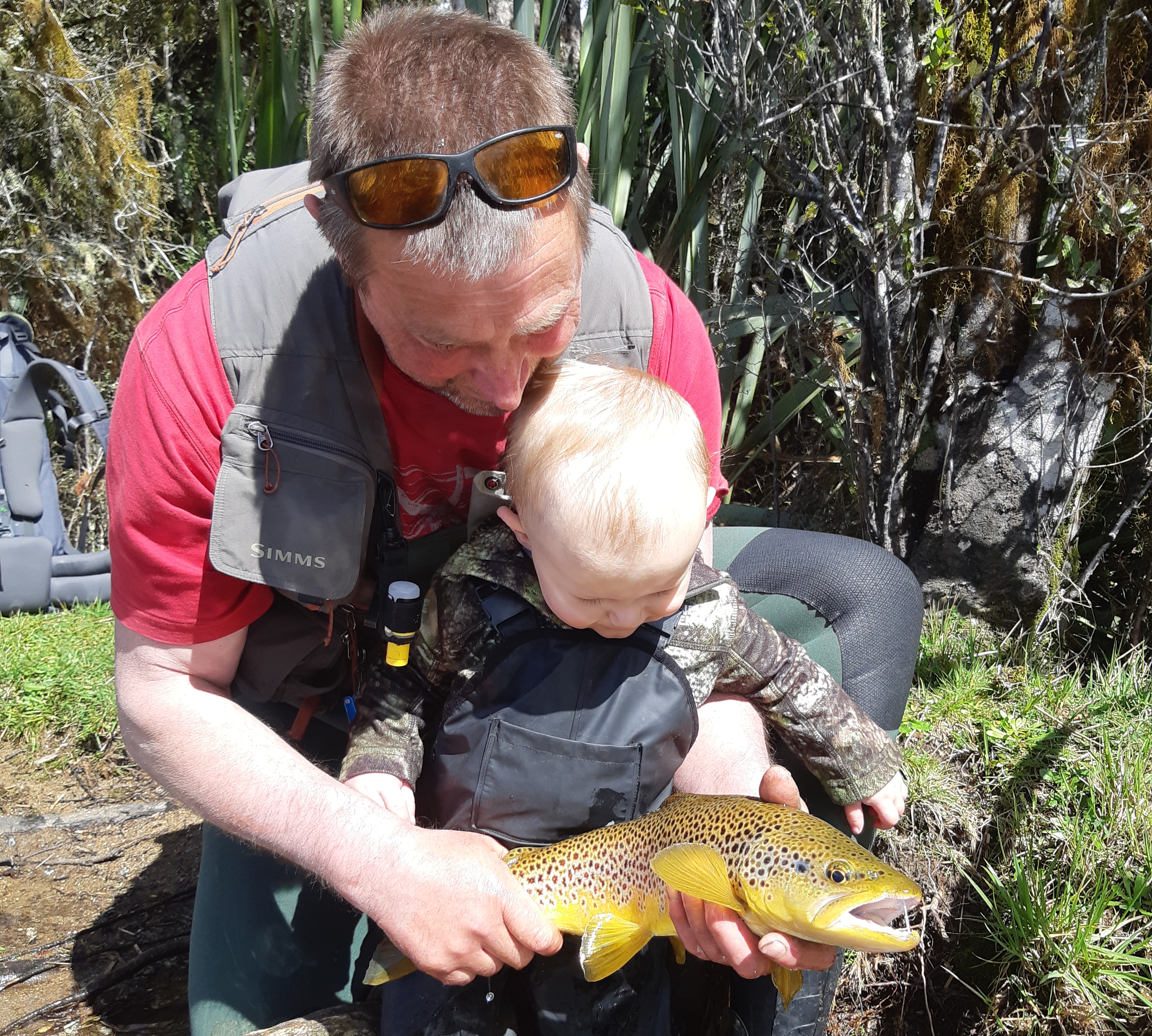 Leo and his grandson Harrison admiring a beautiful West Coast brown trout caught recently. Photo Baylee Kersten