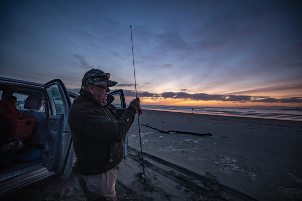 Angler Neil Goldie sets up his salmon rig at the Waimakariri Mouth.