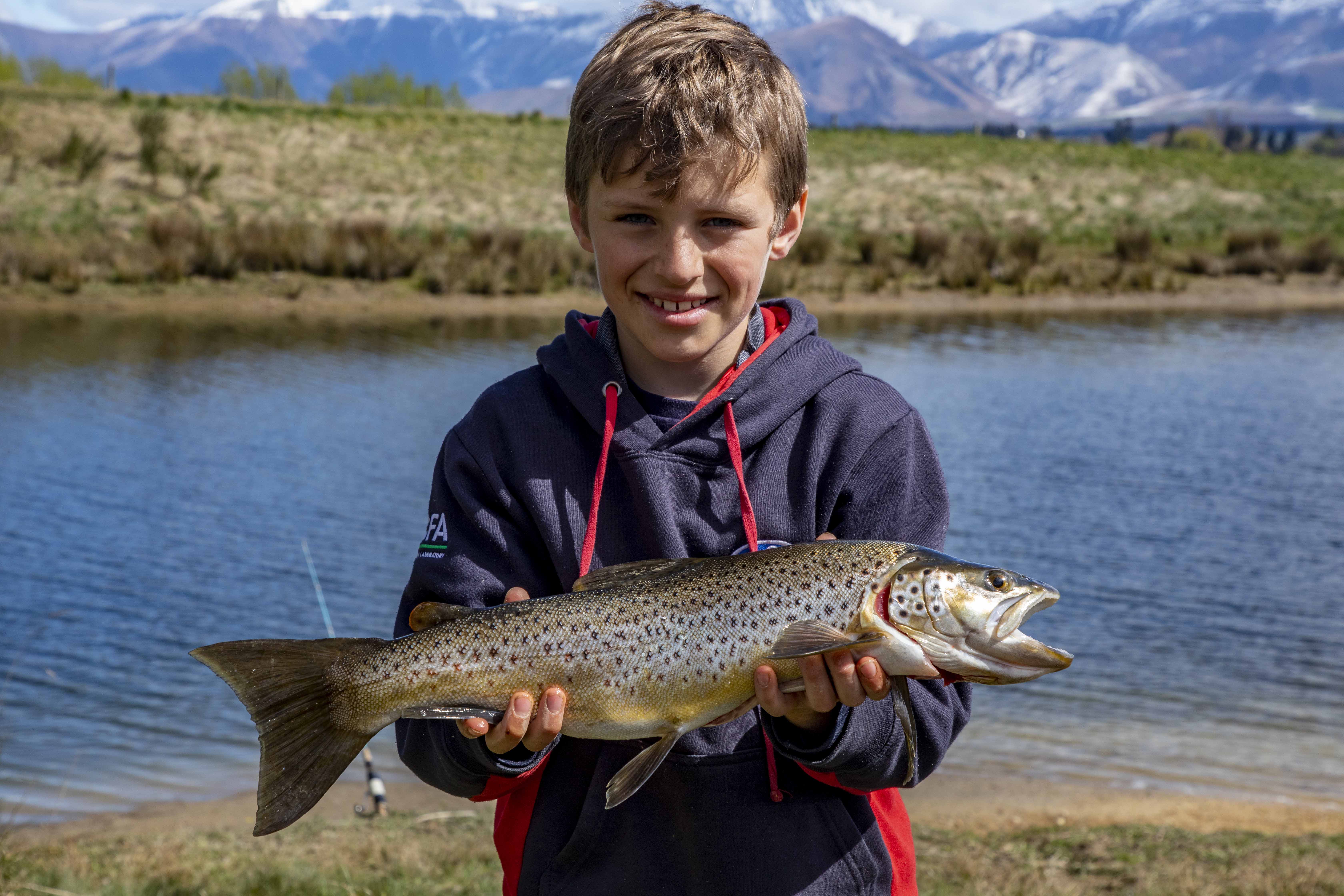WFR1920.05 Nine year old Blake Marrett had success with wormfishing on Lake Opuha with this lovely brown trout credit R Cosgrove