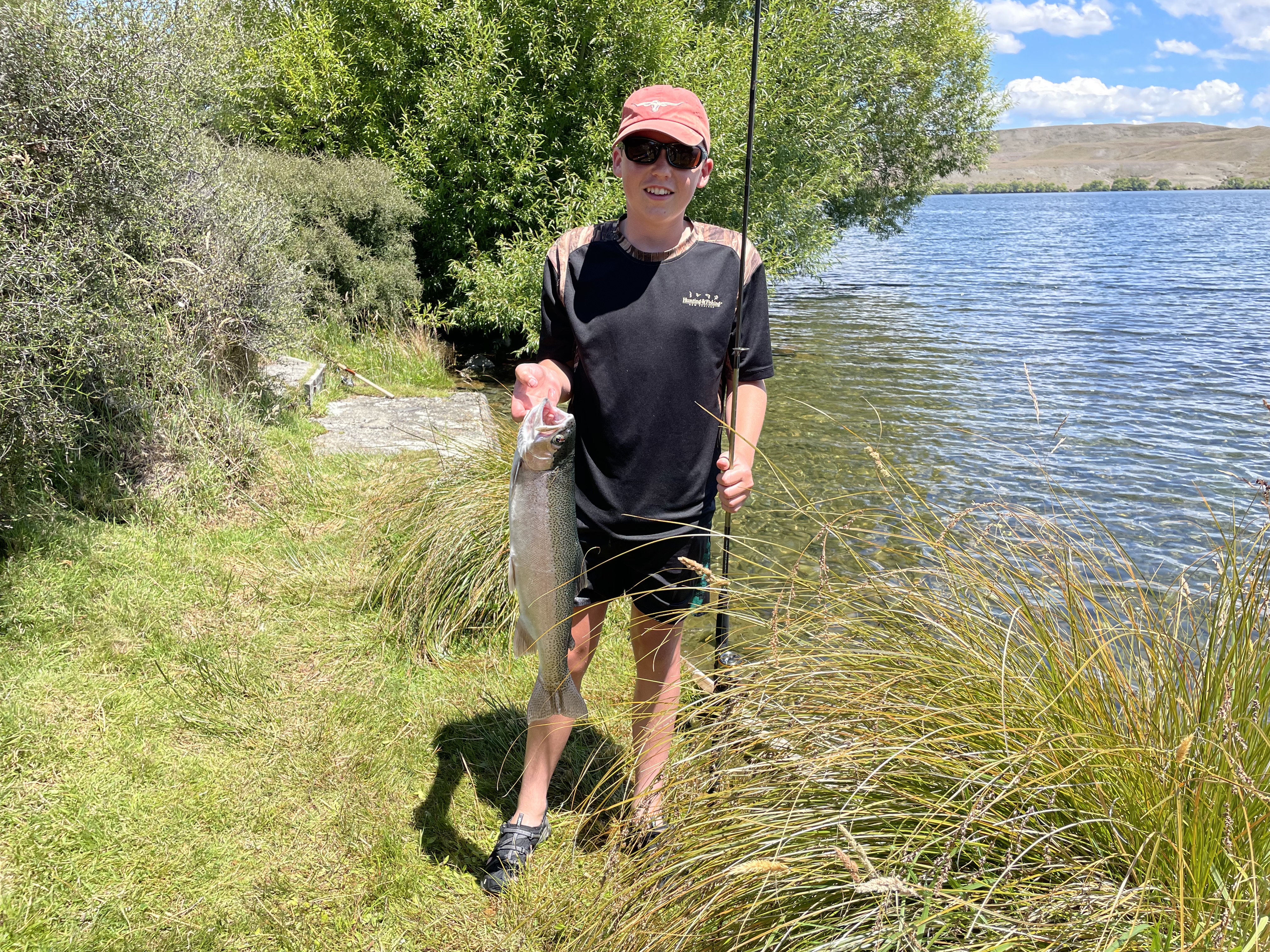 WFR2122.41 Sam Tiffens first ever trout a very nice rainbow caught spin fishing from the shore of Lake Alexandrina photo by Trevor Streeter