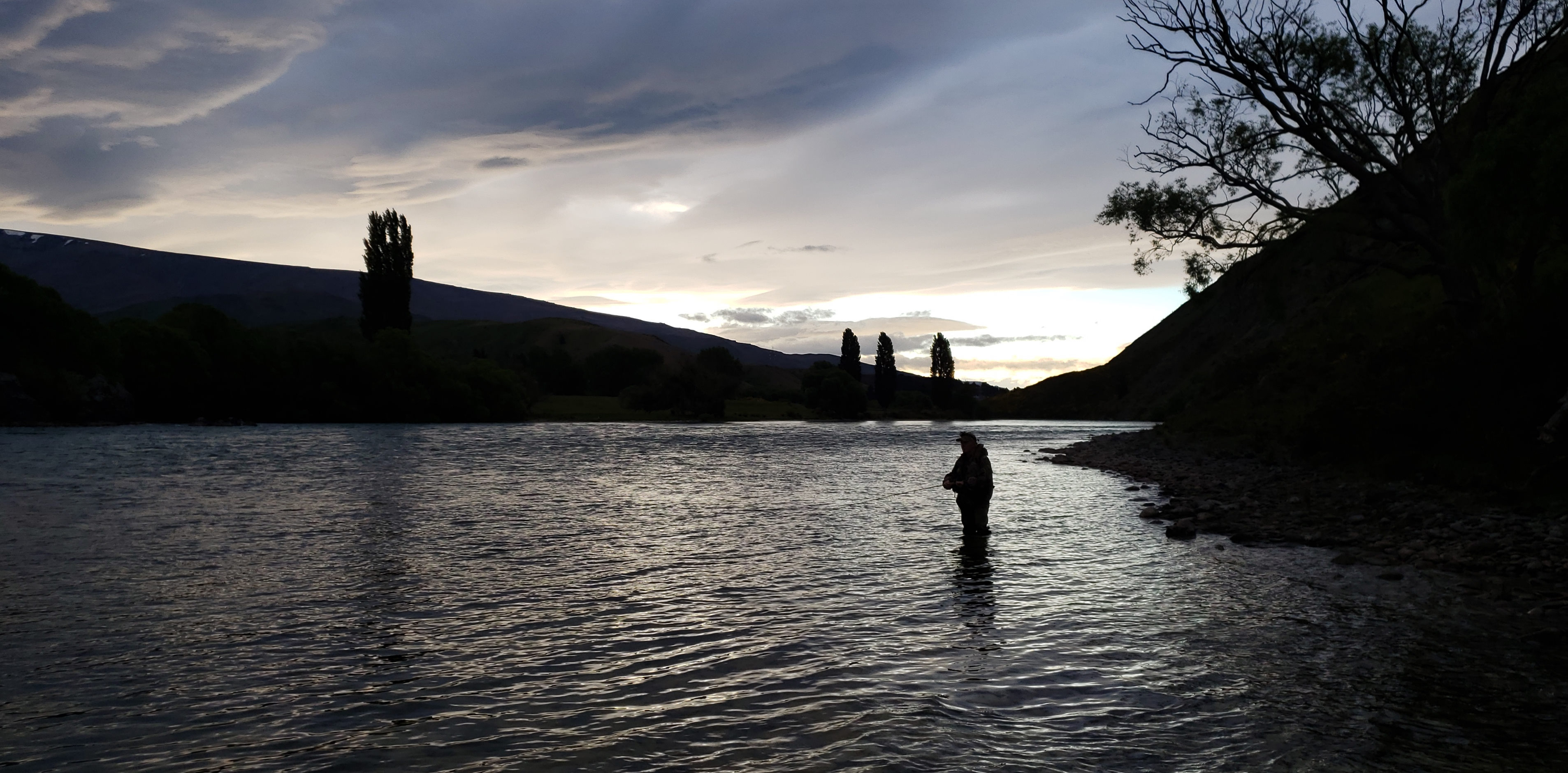 WFR1920.23Graeme Hughes fishing the evening rise on the Waitaki River Credit R Adams