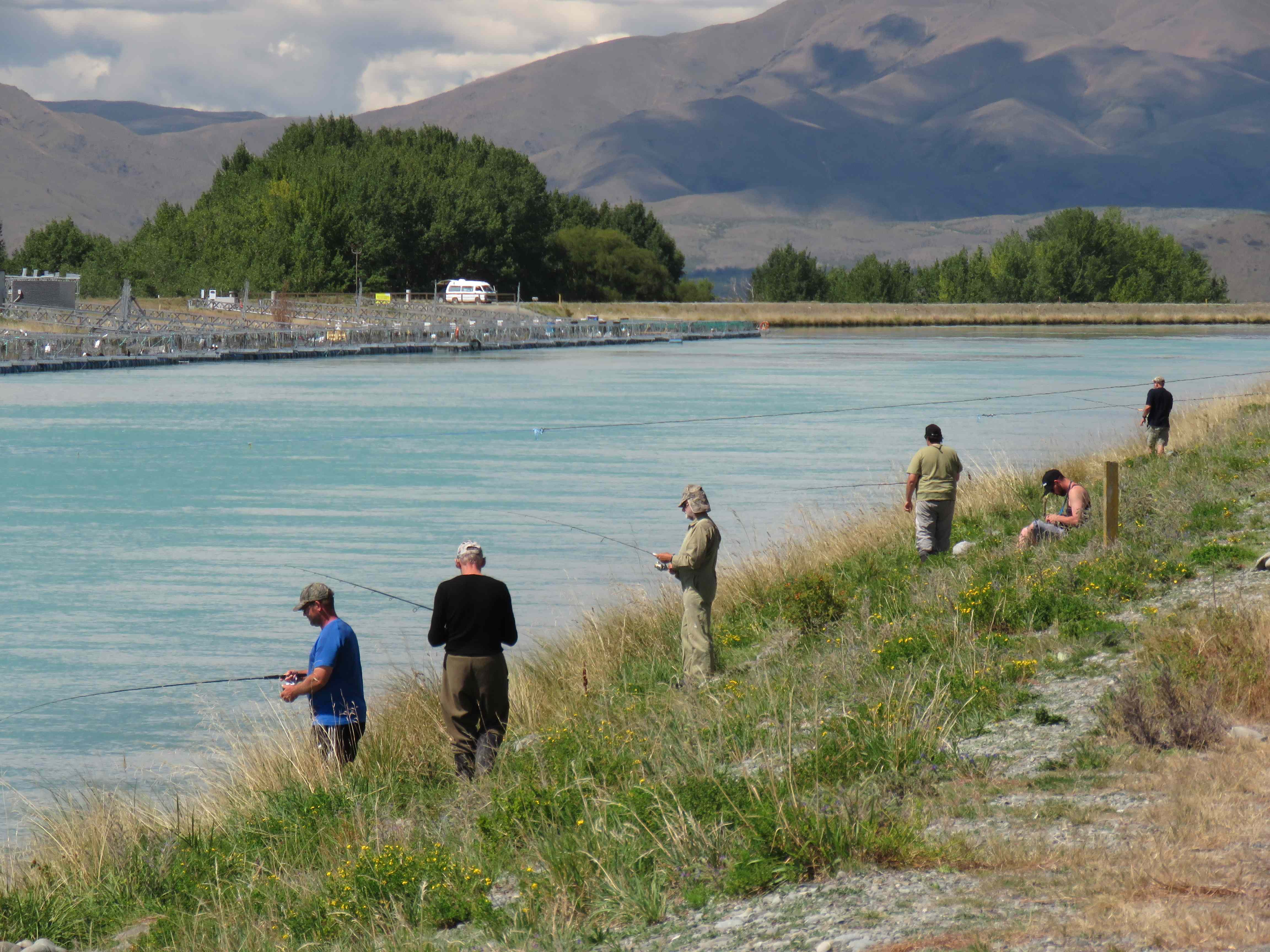 WFR1819.30a group of anglers walk the Ohau C Canal bank bouncing thier lures along the canal bed credit R Adams